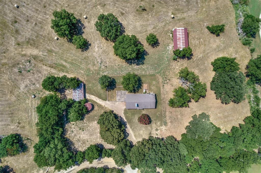 an aerial view of a house with yard and outdoor seating