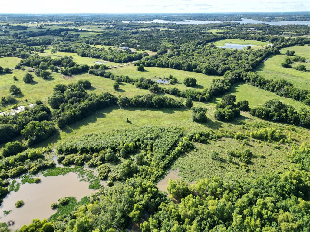 2102 County Road 2610 Bonham, TX 75418 - Photo 13 of 24 an aerial view of residential houses with outdoor space and trees