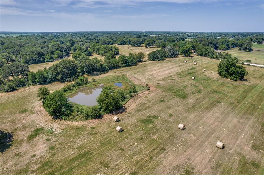 2102 County Road 2610 Bonham, TX 75418 - Photo 14 of 24 a view of a big yard with wooden fence