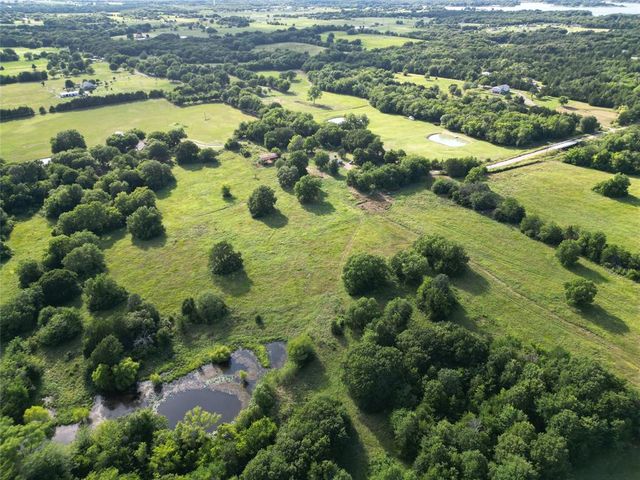 a view of a lake with houses in the back