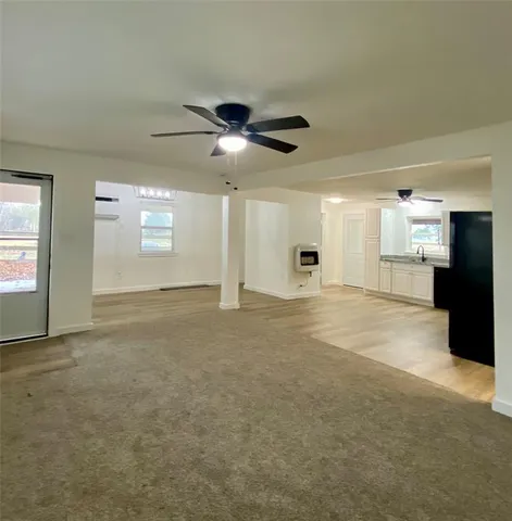 a view of an empty room with a kitchen