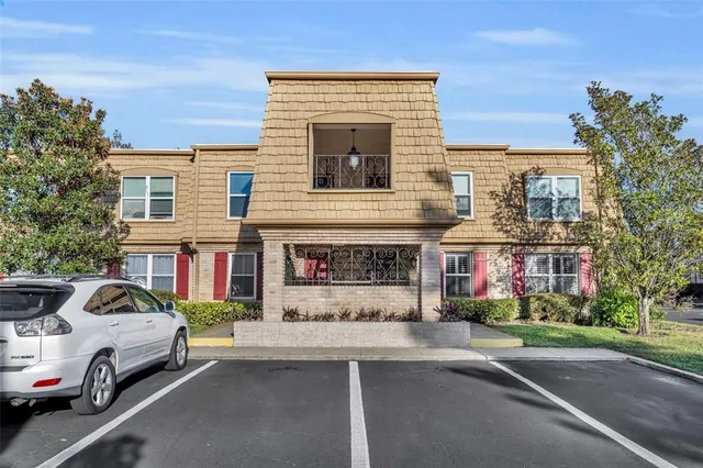 a couple of cars parked in front of a building