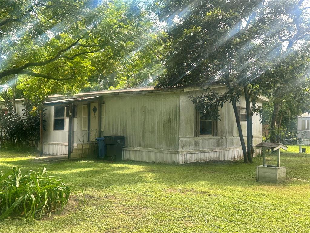 11357 Pruett Road Seffner, FL 33584 - Photo 4 of 6 a view of back yard of the house with swimming pool
