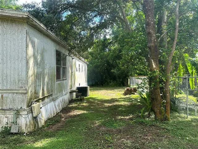a backyard of a house with table and chairs