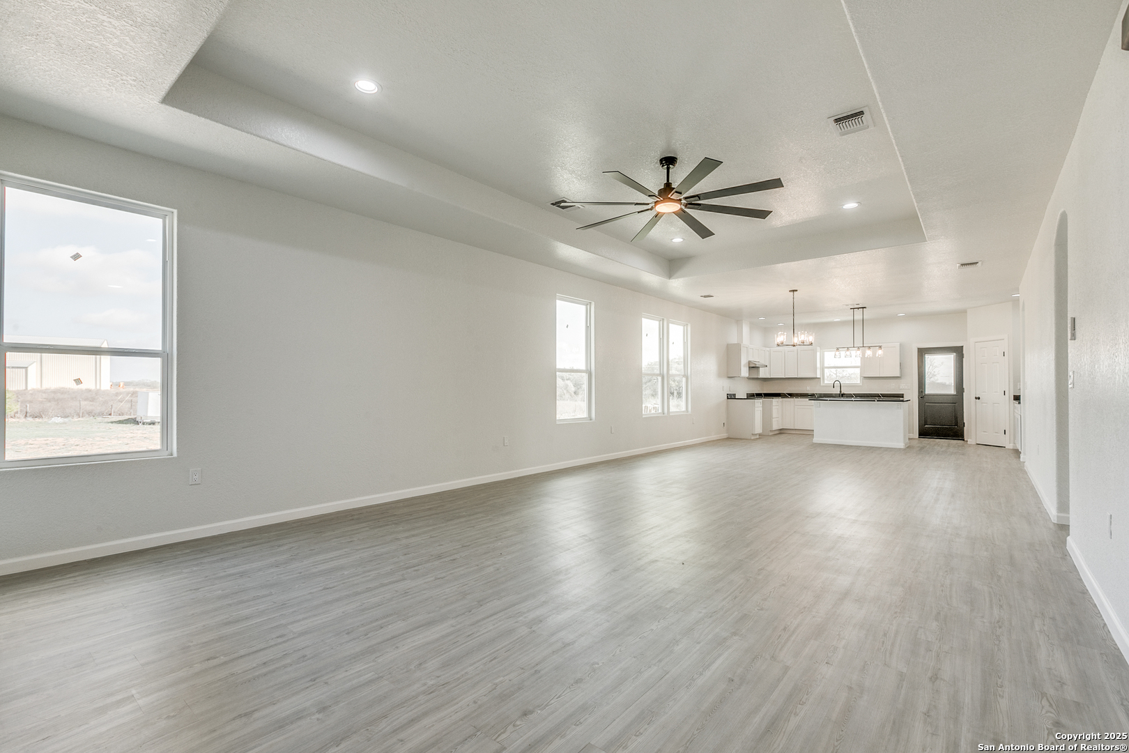 104 Flor Del Sol Road San Antonio, TX 78264 - Photo 11 of 29 an empty room with windows and ceiling fan