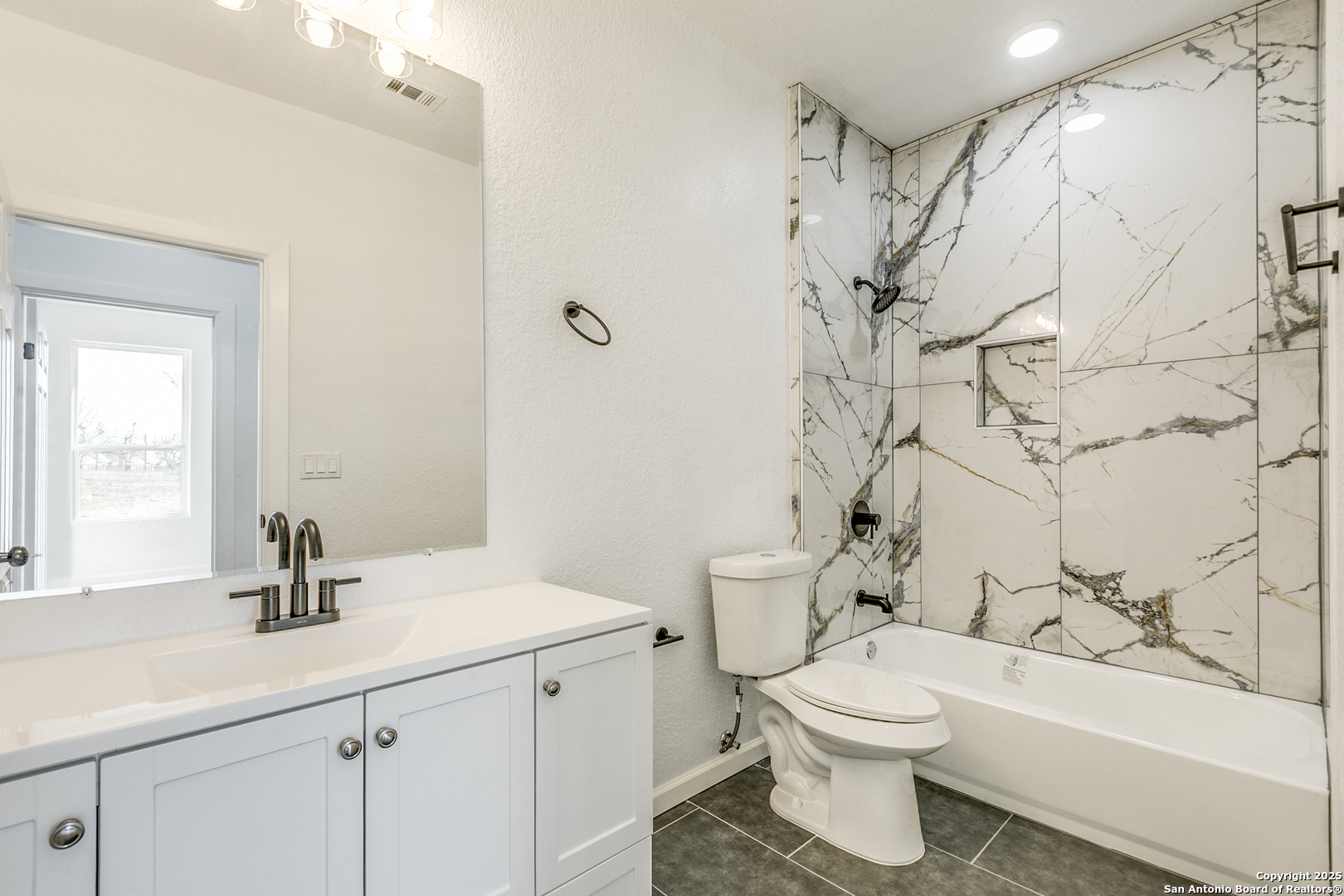 104 Flor Del Sol Road San Antonio, TX 78264 - Photo 16 of 29 a bathroom with a sink a toilet and a bathtub