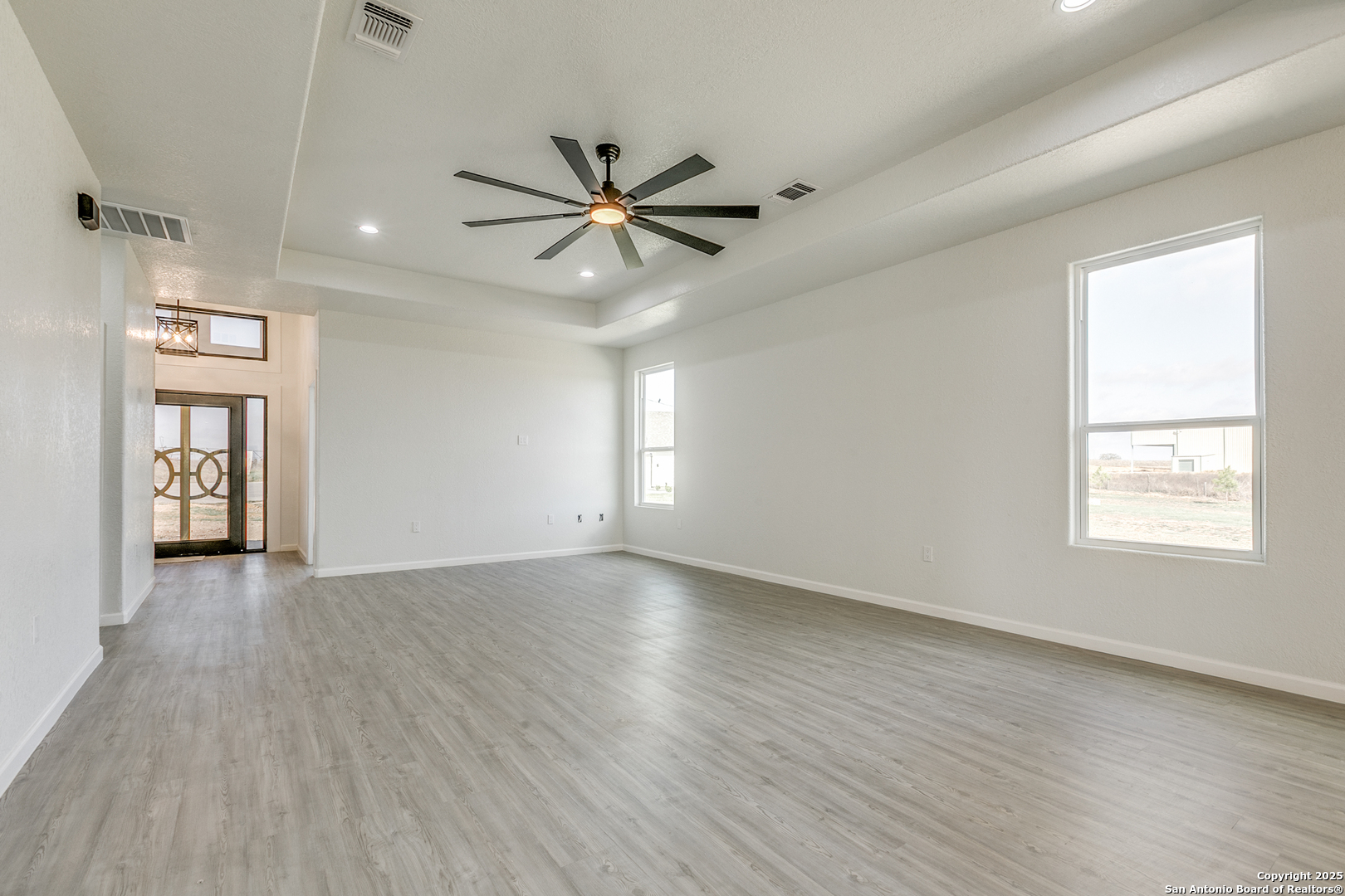 104 Flor Del Sol Road San Antonio, TX 78264 - Photo 17 of 29 a view of an empty room with a window and wooden floor