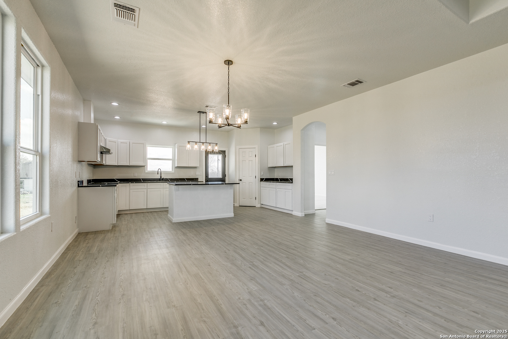 104 Flor Del Sol Road San Antonio, TX 78264 - Photo 19 of 29 a view of a kitchen with a sink dishwasher a refrigerator and wooden floor