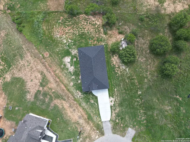 an aerial view of a house with a yard