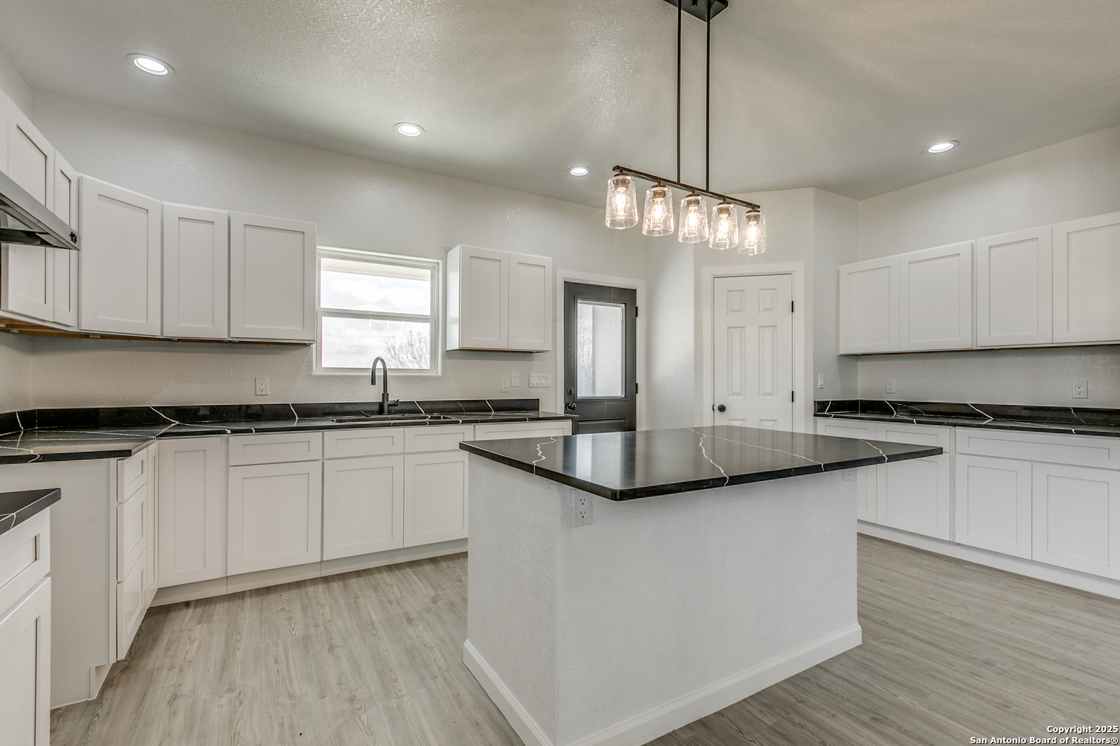 104 Flor Del Sol Road San Antonio, TX 78264 - Photo 22 of 29 a kitchen with stainless steel appliances granite countertop a sink a stove and cabinets