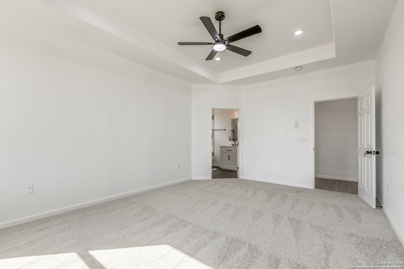 104 Flor Del Sol Road San Antonio, TX 78264 - Photo 25 of 29 an empty room with a ceiling fan and carpet