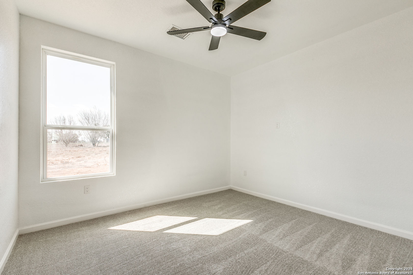 104 Flor Del Sol Road San Antonio, TX 78264 - Photo 28 of 29 an empty room with a window