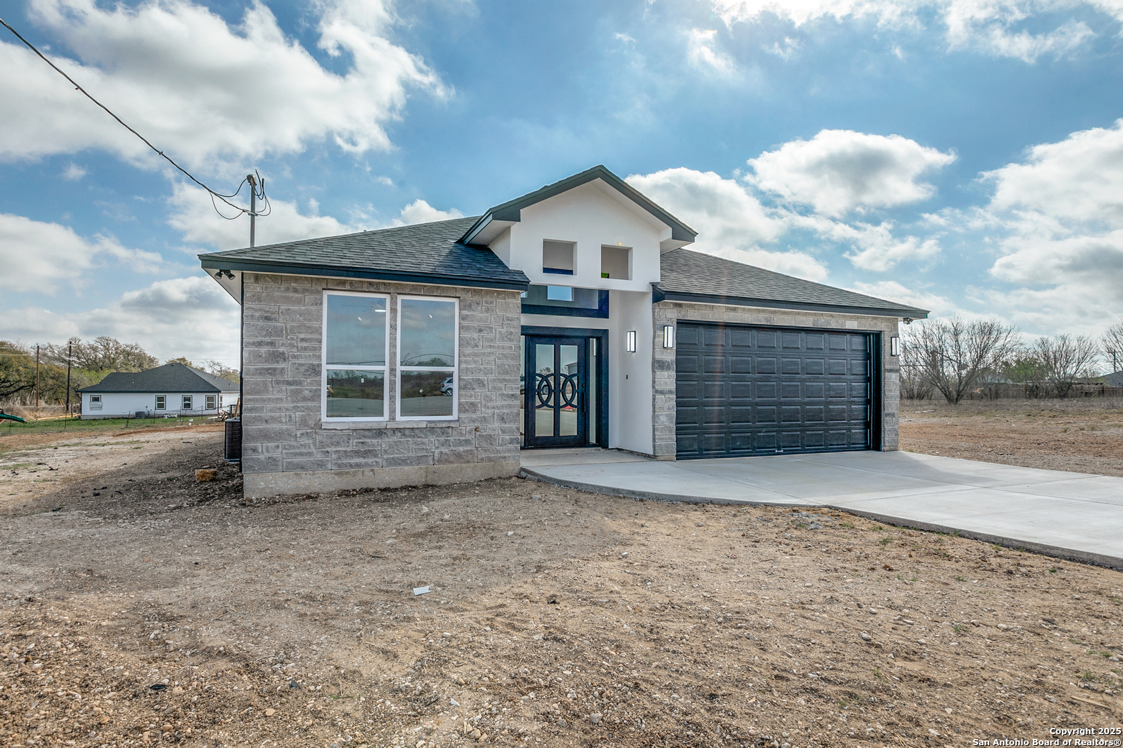 104 Flor Del Sol Road San Antonio, TX 78264 - Photo 5 of 29 a front view of a house with a yard and garage