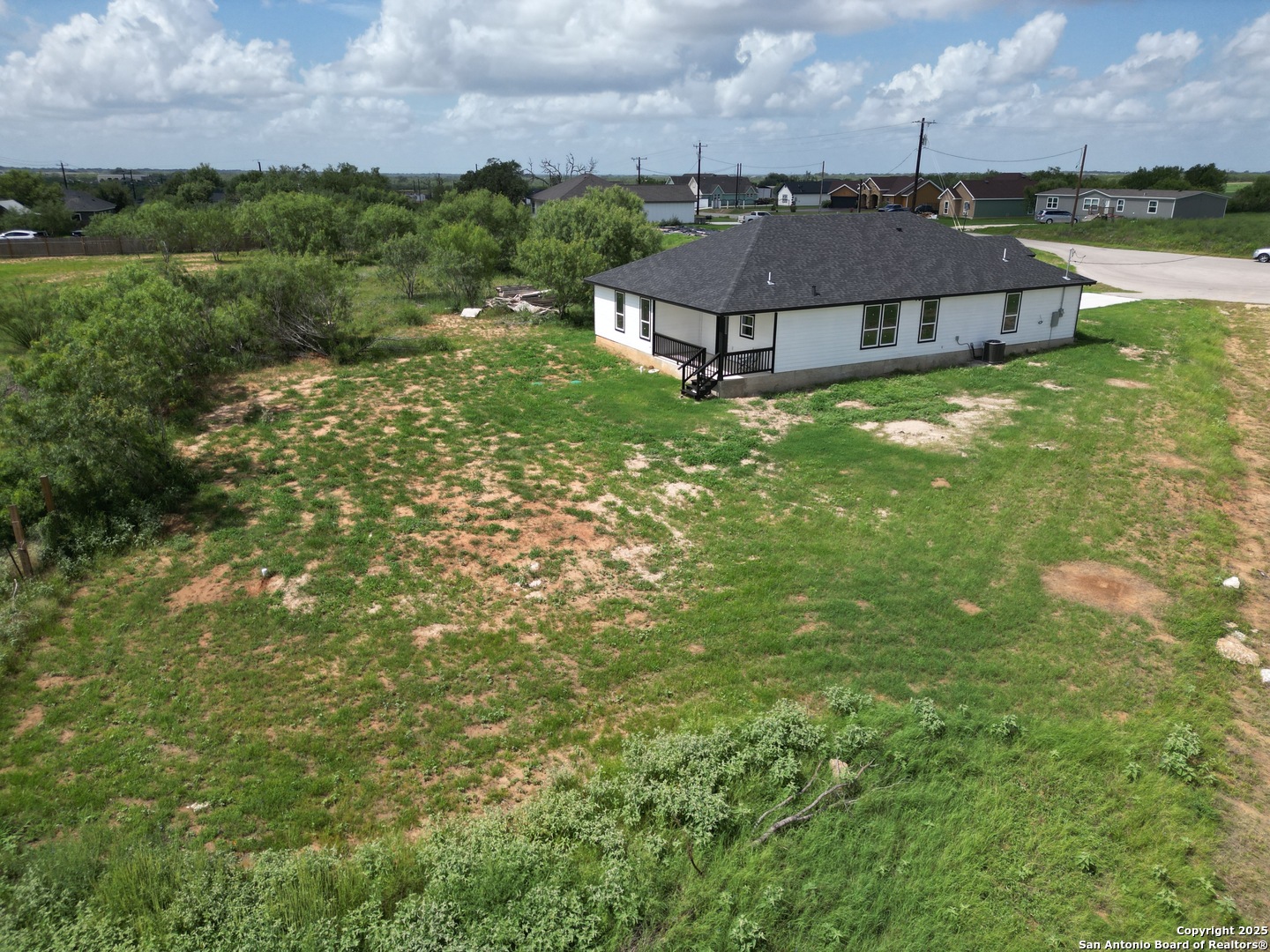 104 Flor Del Sol Road San Antonio, TX 78264 - Photo 6 of 29 an aerial view of a house with a garden and lake view