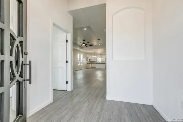 a view of a hallway with wooden floor