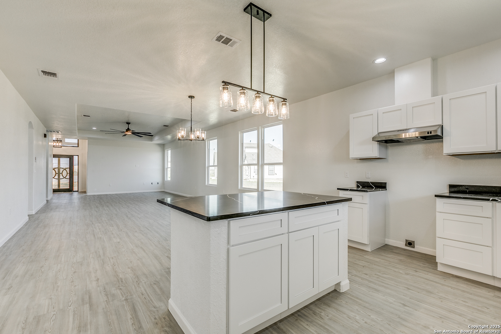 104 Flor Del Sol Road San Antonio, TX 78264 - Photo 10 of 29 a kitchen with stainless steel appliances granite countertop a sink a stove and a wooden floors