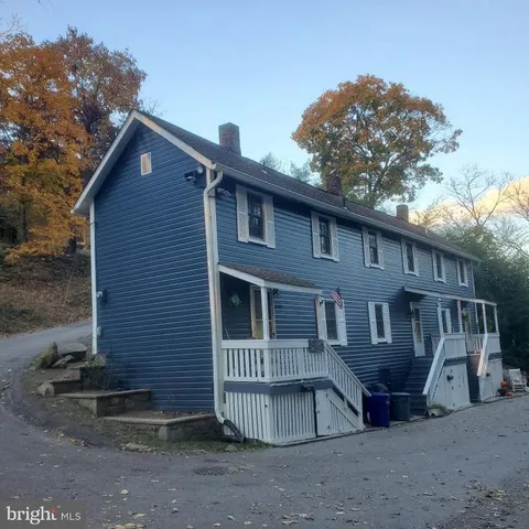 a view of a house with a yard and wooden fence
