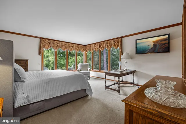 a spacious bathroom with a granite countertop sink mirror and shower