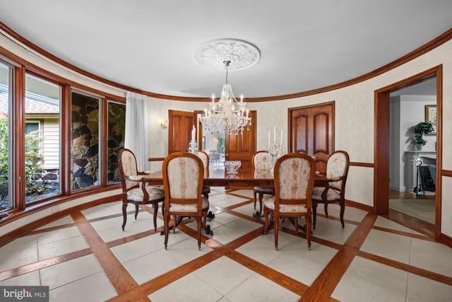 a dining room with furniture a chandelier and fireplace