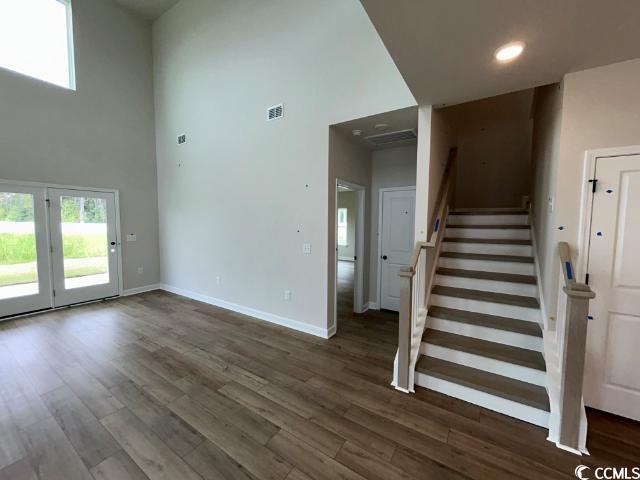249 Valerio Street Myrtle Beach, SC 29579 - Photo 26 of 39 Stairs featuring a towering ceiling and wood-type