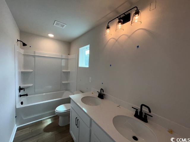 249 Valerio Street Myrtle Beach, SC 29579 - Photo 35 of 39 Full bathroom featuring vanity, toilet, hardwood /