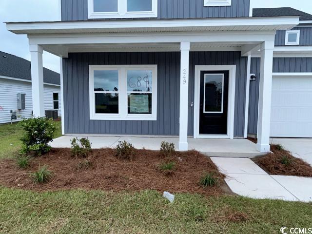 249 Valerio Street Myrtle Beach, SC 29579 - Photo 4 of 39 View of exterior entry featuring a garage and a po