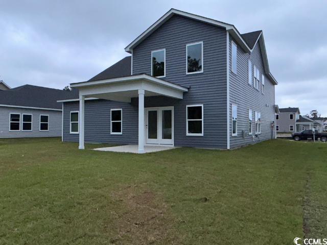 249 Valerio Street Myrtle Beach, SC 29579 - Photo 7 of 39 Rear view of house featuring a lawn and a patio