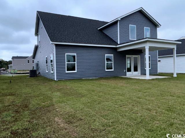 249 Valerio Street Myrtle Beach, SC 29579 - Photo 8 of 39 Rear view of property featuring a lawn, a patio ar