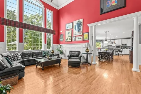 a dining room with furniture a chandelier and wooden floor