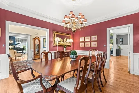 a living room with furniture a rug and a floor to ceiling window