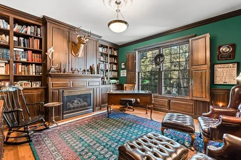 a bedroom with two beds and painting on the wall