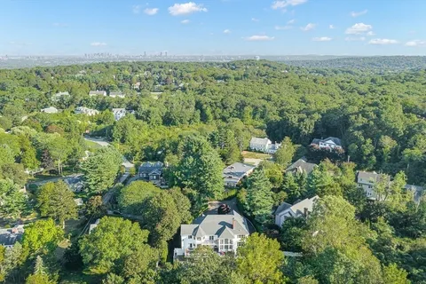 an aerial view of a house with swimming pool and garden