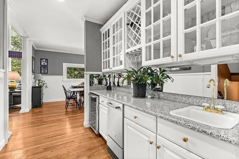 a living room with furniture large window and fireplace