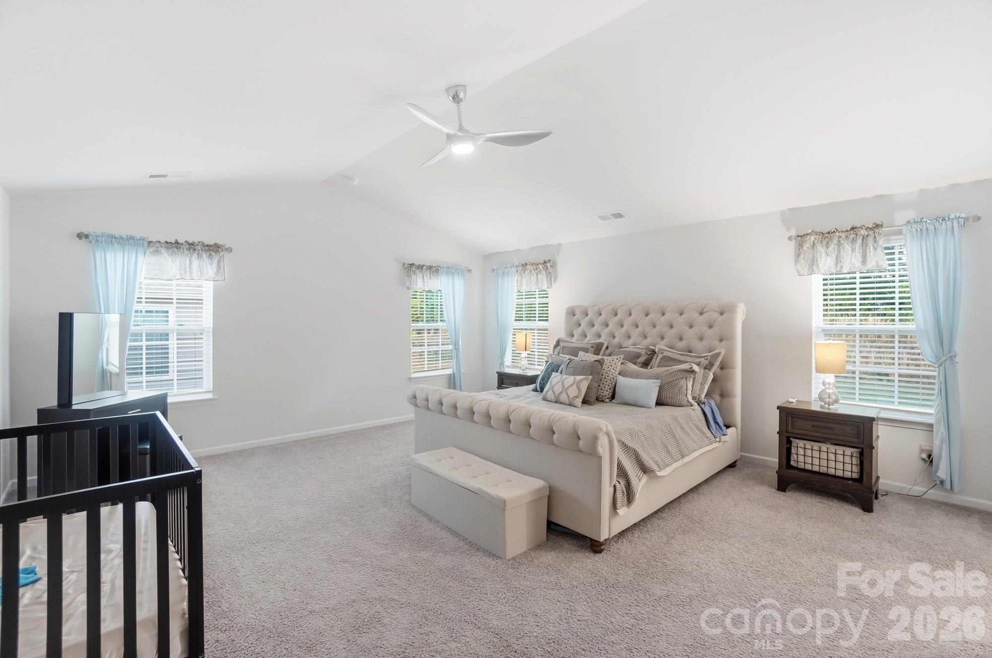 116 Timbergreen Court Troutman, NC 28166 - Photo 21 of 43 a spacious bedroom with a bed and a couch