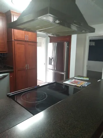 a view of wooden floor and a chandelier in a room