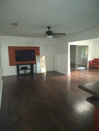 a living room with couches and a coffee table with wooden floor