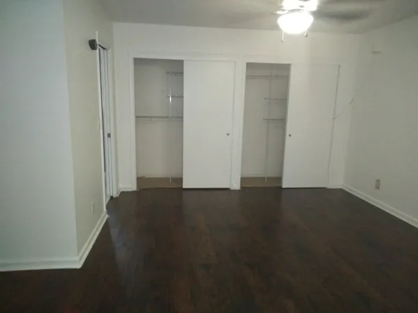 a bathroom with a granite countertop toilet sink and mirror