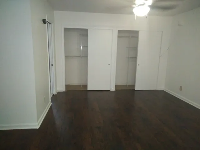a bathroom with a granite countertop toilet sink and mirror