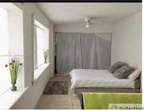 a white toilet sitting next to a shower curtain