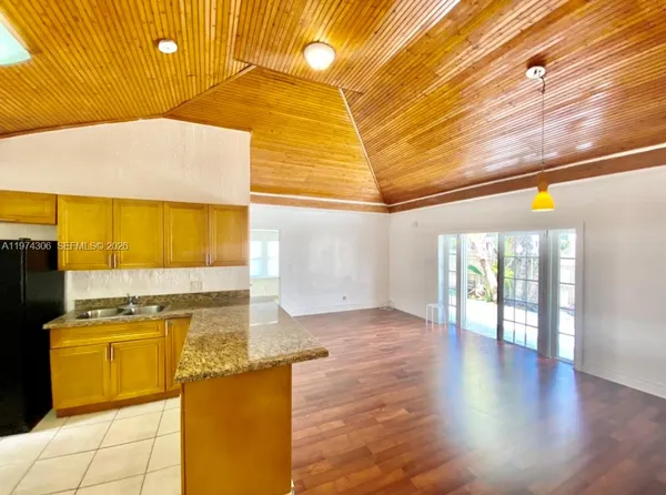 a kitchen with a sink appliances and cabinets