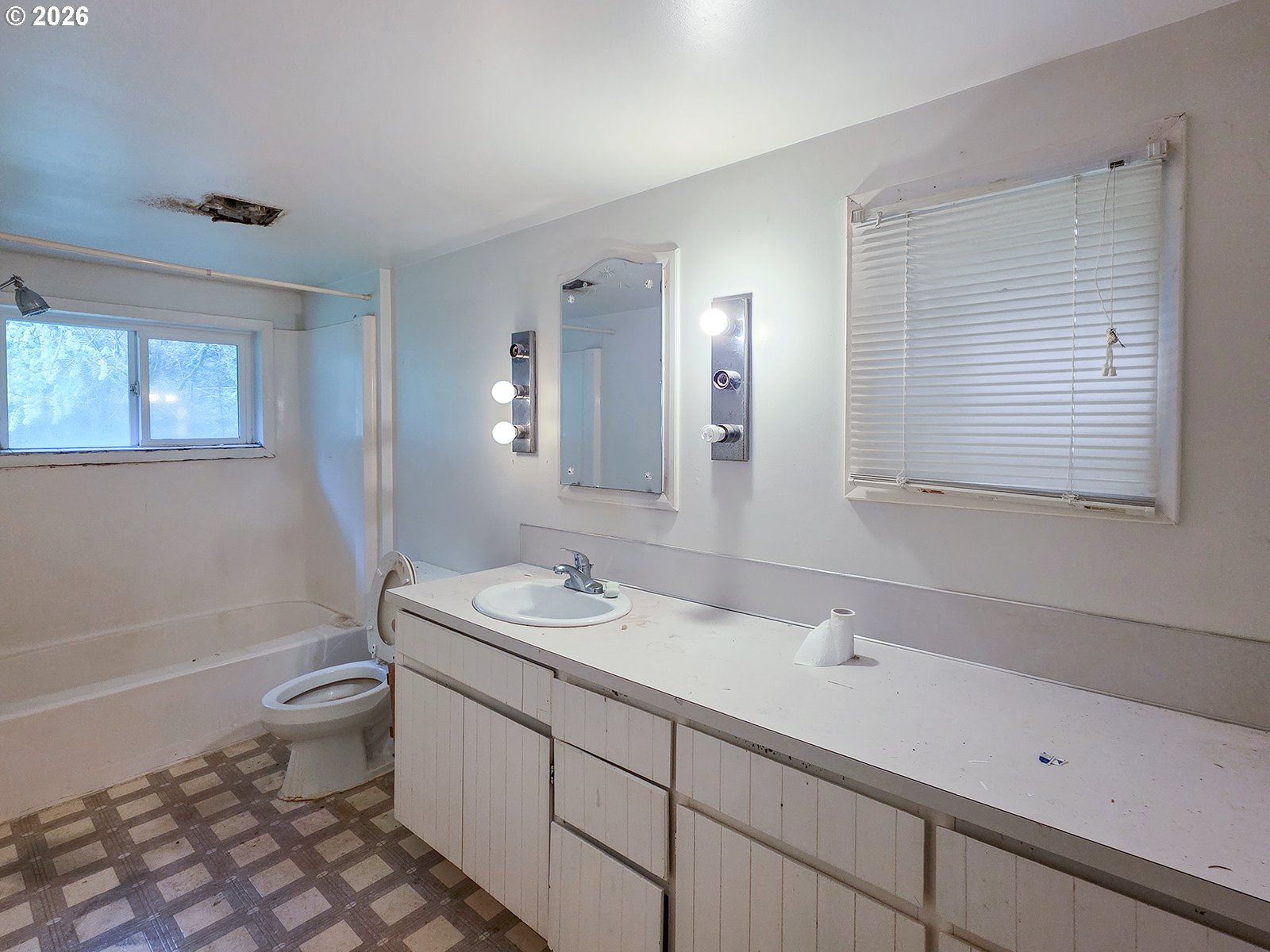 4410 Southeast Aldercrest Road Milwaukie, OR 97222 - Photo 16 of 28 a bathroom with a double vanity sink toilet and mirror