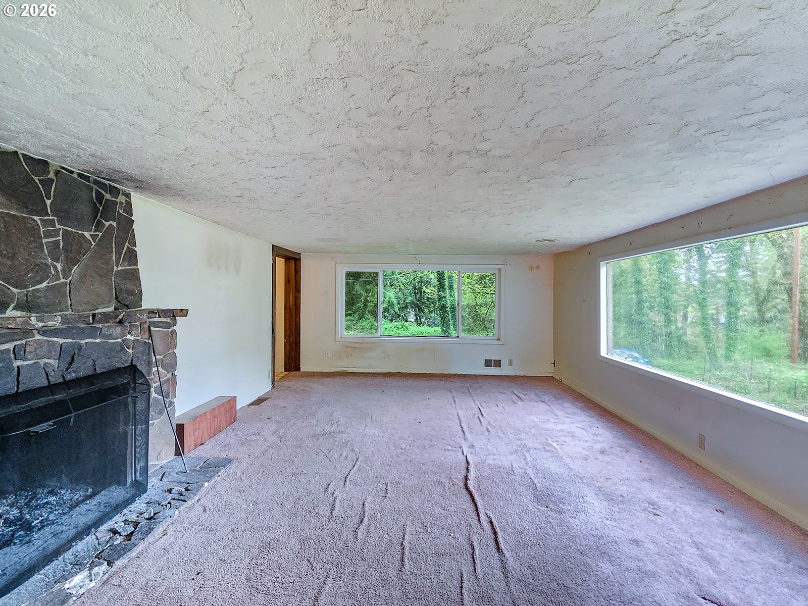 4410 Southeast Aldercrest Road Milwaukie, OR 97222 - Photo 6 of 28 a view of a livingroom with an empty space and a fireplace