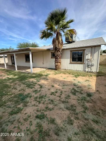 a house that has a tree in front of it