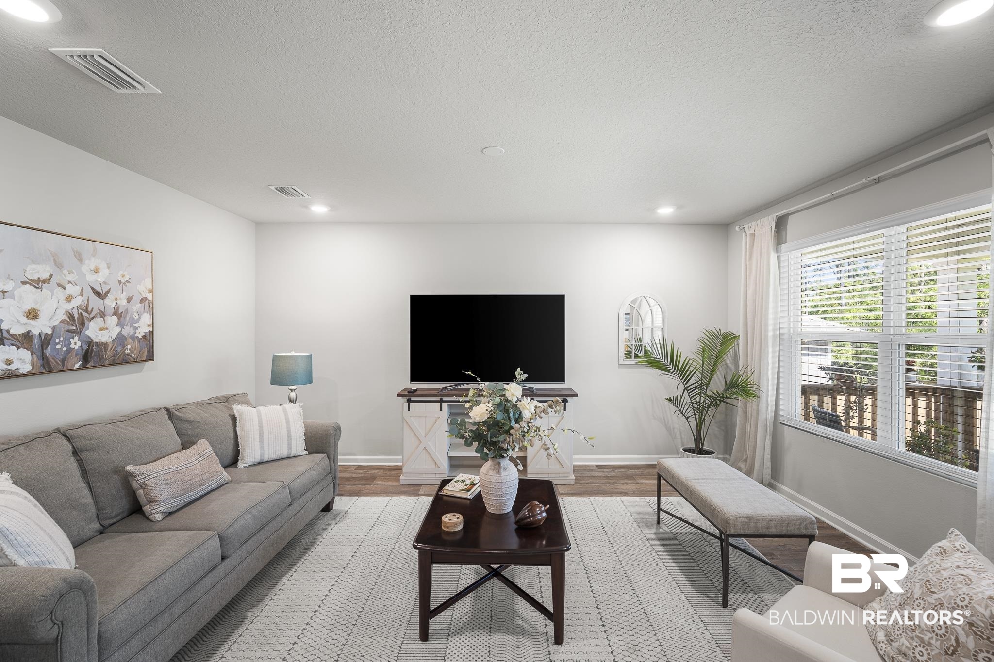 10232 Brodick Loop Spanish Fort, AL 36527 - Photo 5 of 29 Living room featuring light wood-style floors, recessed lighting, baseboards, and a textured ceiling