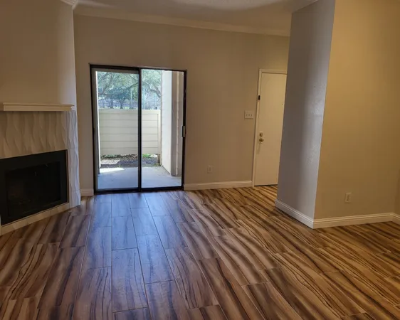 wooden floor in an empty room with a fireplace