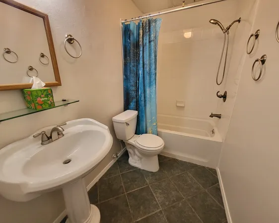 a bathroom with a toilet sink and shower
