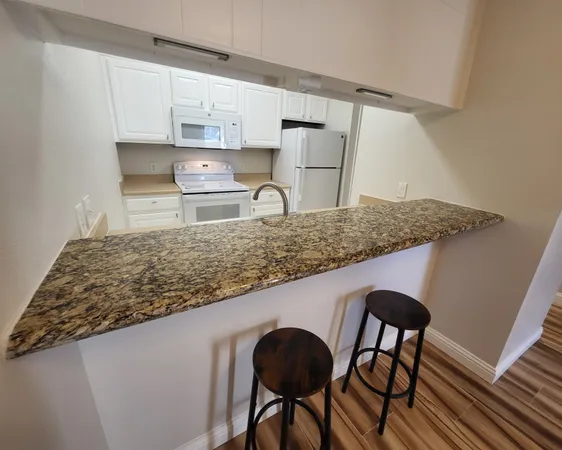 a kitchen with a table and chairs in it