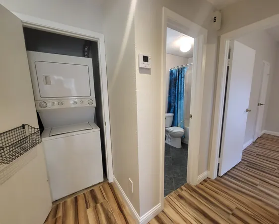 a view of hallway with wooden floor
