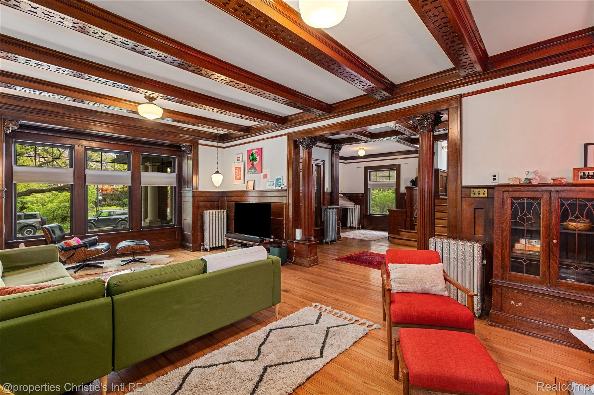 36 Longfellow Street Detroit, MI 48202 - Photo 11 of 81 Living area featuring wainscoting, light wood-style flooring, beamed ceiling, decorative columns, and crown molding