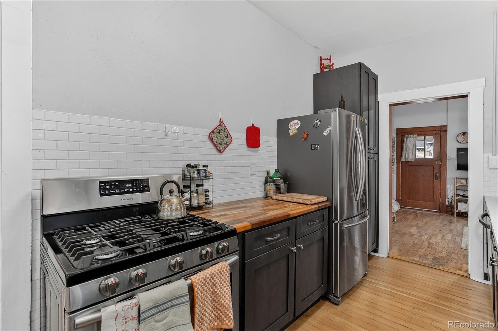 1902 Grove Street Boulder, CO 80302 - Photo 13 of 38 a kitchen with a stove and a wooden floor